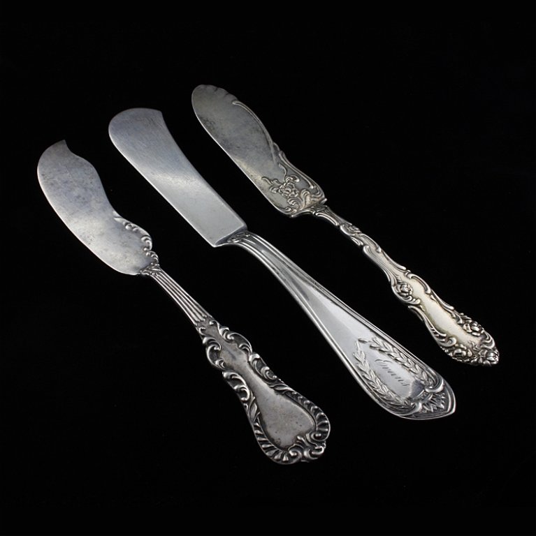 Set of Three Silver Master Butter Knives: Est $ 60-100 Set of three master butter knives including: 1) Master butter knife with a beaded and scroll low relief pattern marked sterling and The Watson Co. The knife measures 7" long. 2) Master bu