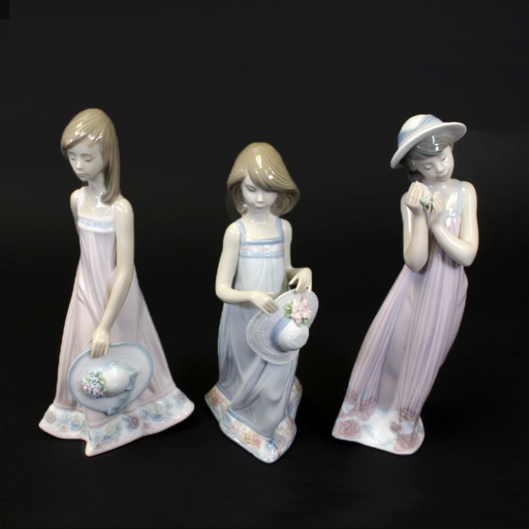 Lladro Porcelain Figures 'Cathy' 'Cindy' & 'Sara': Est $ 300-400 Set of three Lladro figurines including: "Cindy", no. 5646, 8" tall. "Cathy", no. 5643, 7 3/4" tall, designed by Juan Huerta, issued in 1990 and retired in 1998. Cathy measures 7 1/2" ta