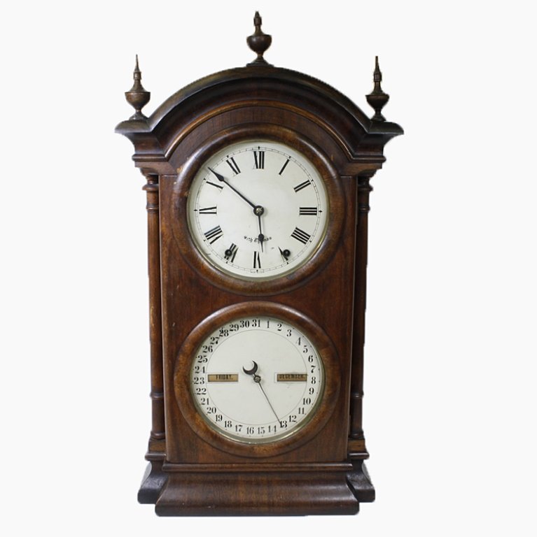 Seth Thomas Mantle Calender Clock: Est. $ 1500-2500 Seth Thomas calender clock. Measures 15 inches wide, 5 inches deep and 26.5 inches tall not including finial. 3 finials adorn the top of the clock. The center finial has a broken tip