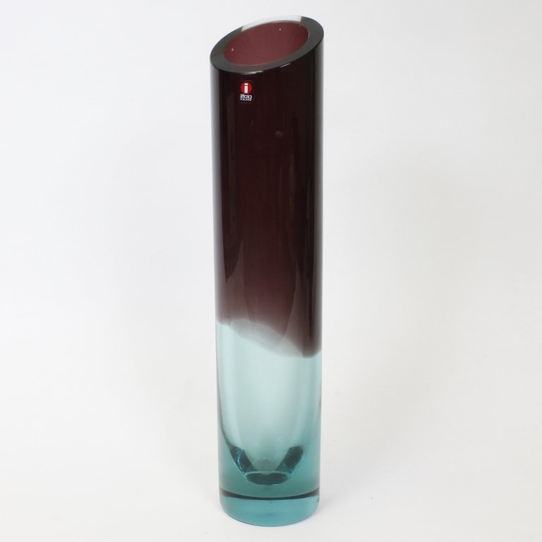 Large Iittala Nuutajarvi Finland Vase: Est $ 150-300 Large cylindrical vase signed Nuutajarvi Kerttu Nurminen with an Iitala Finland sticker. The vase is blue fadded to purple and measures 14 1/2" tall. Third party shipping.