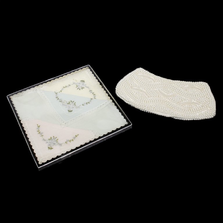 Lot of Two Vintage Items: Est $ 100-200 Lot of two vintage items including: 1) Made in Japan pearl and bead zip clutch that measures 8 1/2" wide x 4 1/2" tall. 1) Set of three lace and embroidered handkerchiefs still in origin