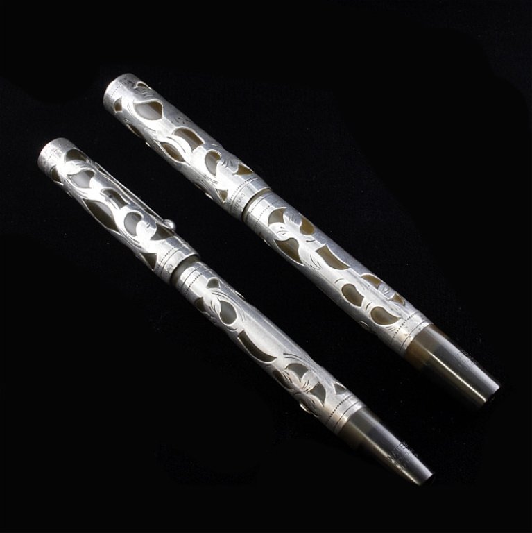 Set of 2 Watman's Ideal Sterling Fountain Pens: Est. $100 - 120 Set of two sterling overlay fountain pens, marked: Waterman's, Ideal, Sterling and Made in U.S.A.