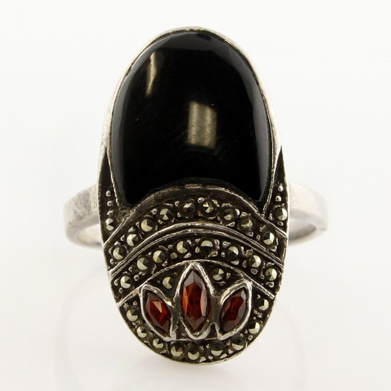 Garnet, Marcasite, and Onyx Sterling Ring: Est. $25 - 40 Garnet, Marcasite, and Onyx Sterling Ring. Weighs 7.0 grams.
