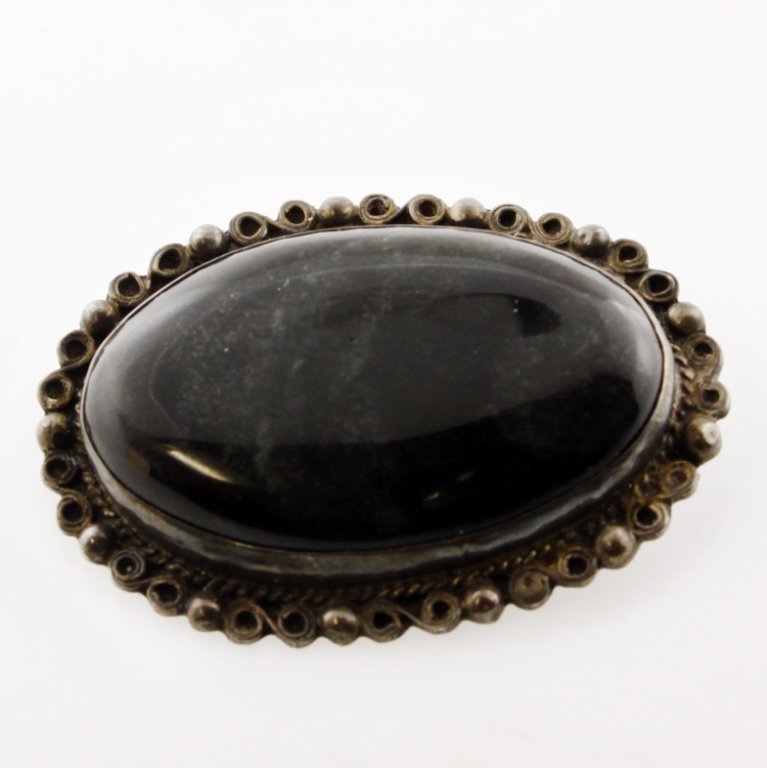 Sterling Taxco Antonio Pineda Pin Brooch: Est. $200 - 300 Sterling Taxco Antonio Pineda Pin Brooch. Weighs 9.2 grams. Dark oval polished agate pin/brooch is 1 3/4 inches wide. Marked with Sterling, Mexico and the mark for Antonio Pineda (Taxc
