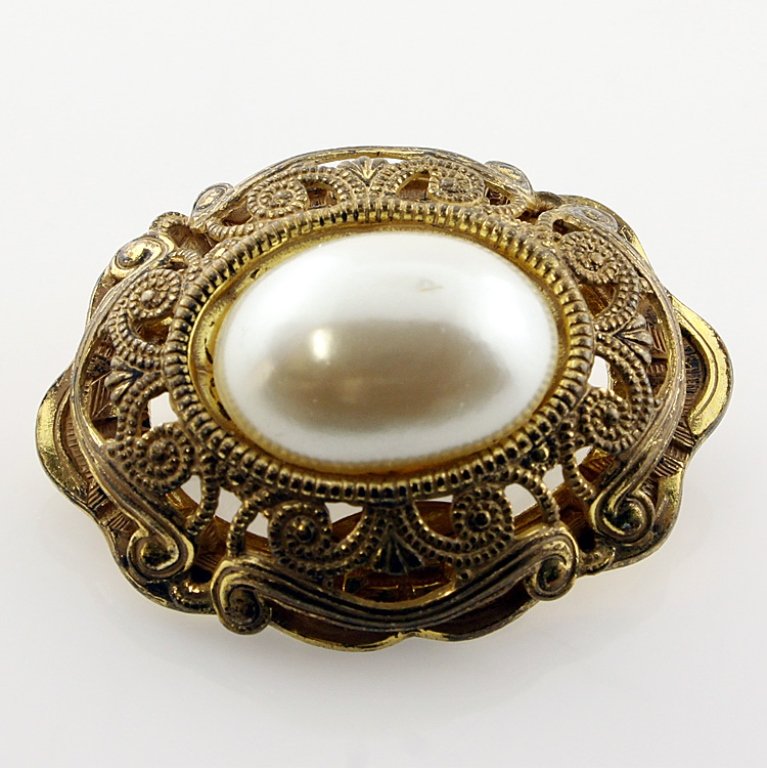 Miriam Haskell Pin Brooch: Est. $45 - 70 Miriam Haskell Pin Brooch. Gold tone with filigree and faux pearl. Approx. 1 1/2 inches. Marked Miriam Haskell.