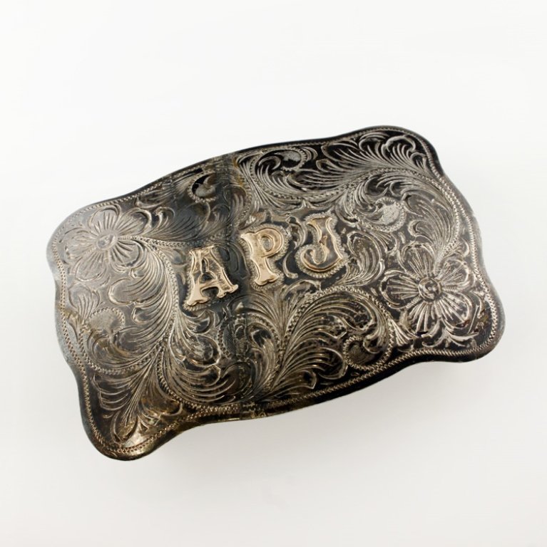 Sterling and Gold Vintage Fleming Belt Buckle: Est. $ 75 - 125. Weighs 71.8 grams. Engraved Western style belt buckle as with initials "A, P & J" in 10k. 3 1/2 x 2 3/8". Marked Fleming Mexico sterling and 10k.