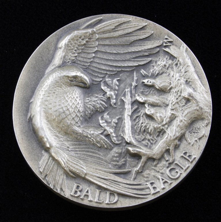 Bald Eagle Sterling Medal: Est. $40 - 60 Bald Eagle Sterling Medal. Bald Eagle design with great depth. This medal is marked Longines Symphonette Sterling, W and 454. This medal explains what the Bald Eagle symbolizes. Weighs 1