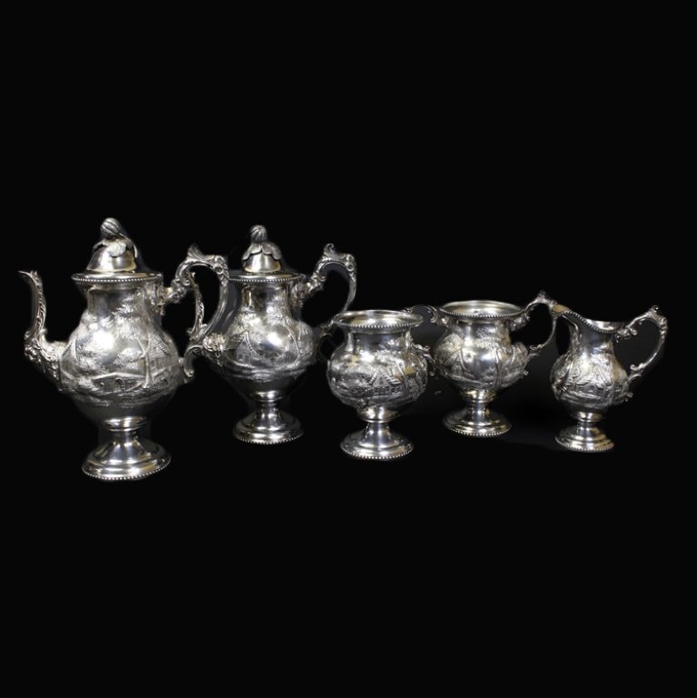 Am. Silver Landscape Pattern 5 Pc.Tea/Coffee Set: Est. $280 - 420 American Silver Landscape Pattern 5 Pc.Tea/Coffee Set. Five piece tea and coffee set with a landscape pattern. Silverplate construction. Marked 1950 on bases. Tallest pitcher is 12 inc