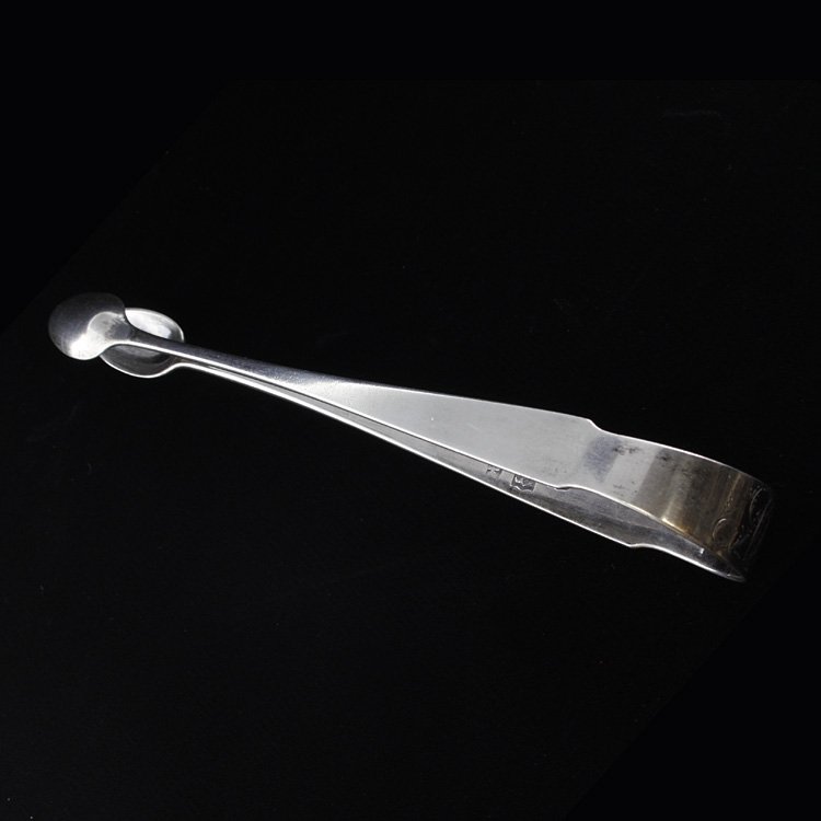 John Vernon Coin Silver Tongs: Est. $50 - 75 John Vernon Coin Silver Tongs . Weighs 1.32 ozt. Circa 1800. Measures 6.25 inches.