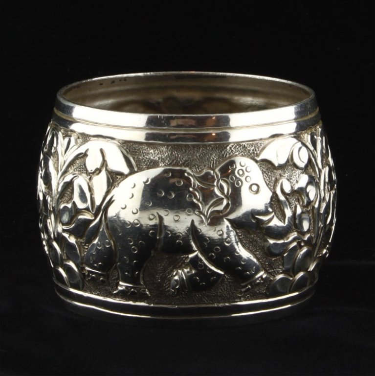 Elephant Scene Napkin Ring: Est. $30 - 60 Elephant Scene Napkin Ring. Weighs 1.08 ozt. Measures 1.25" tall by 1.75" wide. Non Marked. Tested as sterling.