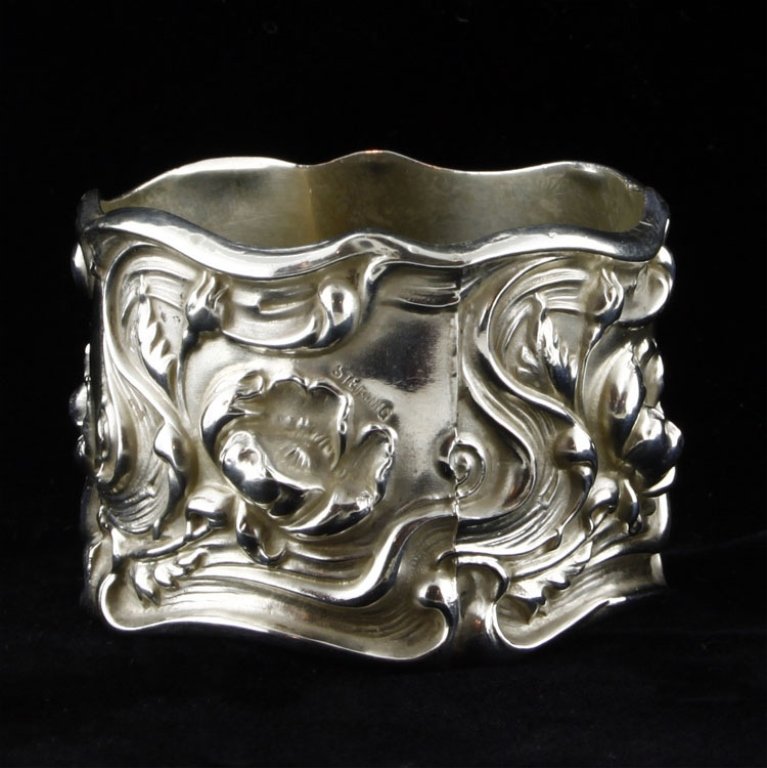 Sterling Floral Napkin Ring: Est. $25 - 35 Sterling Floral Napkin Ring. Weighs .75 ozt. Measures 1.25" tall by 1.75" wide. Monogrammed on inside. Marked Sterling