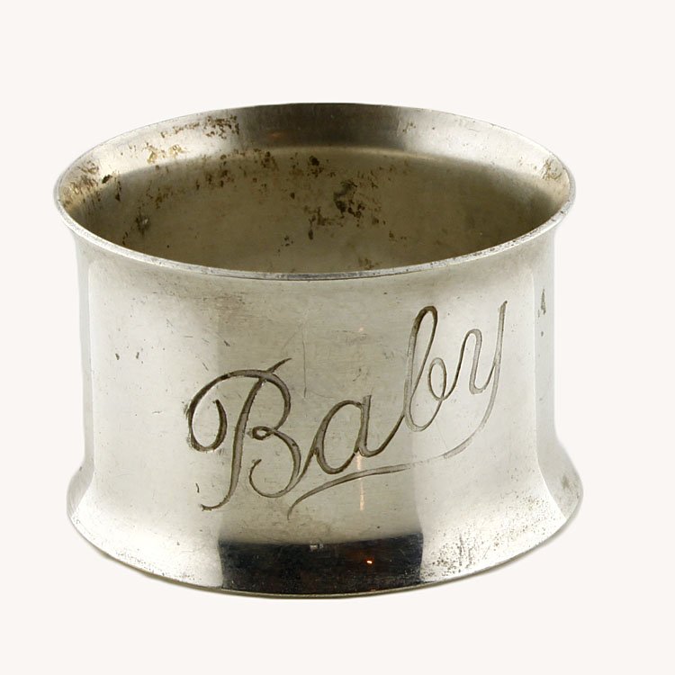 Child's Napkin Ring: Est. $20 - 30 Child's Napkin Ring. Weighs .40 ozt. Measures .875" tall by 1.375" wide. Monogrammed "Baby"