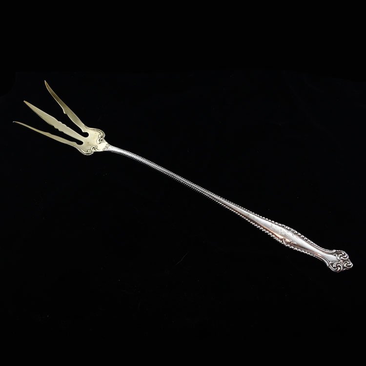 Towle Sterling Lettuce Fork: Est. $30 - 45 Towle Sterling Lettuce Fork. Sterling silver lettuce fork by Towle in the Canterbury pattern, monogrammed "G" on the handle. Measures 9" long. Weighs .945ozt. Marks: Towle makers mark, s