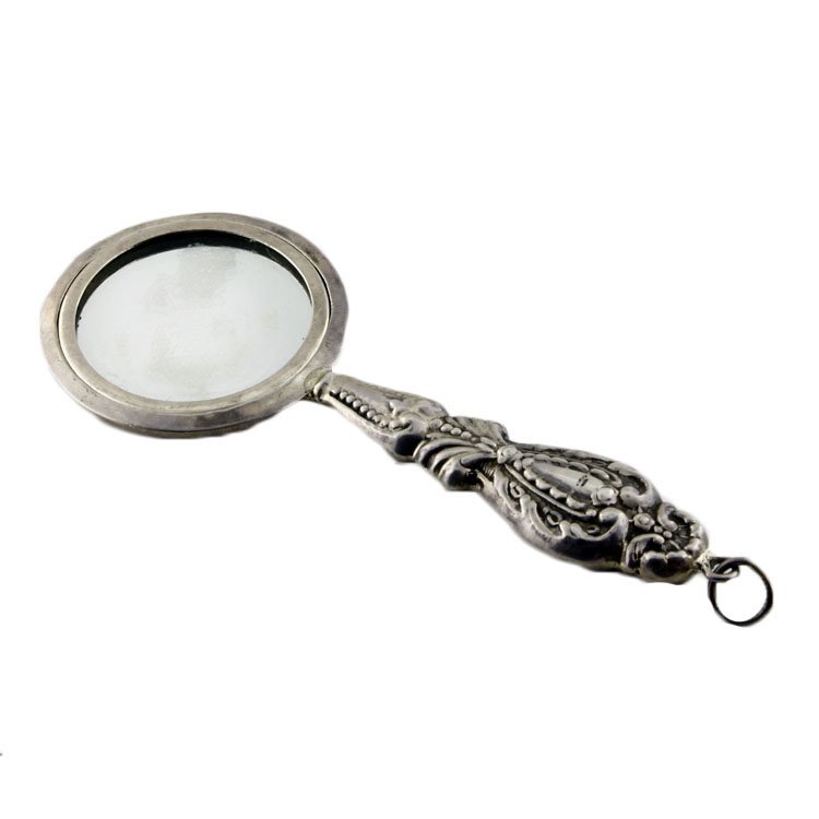 Sterling Handled Mirror: Est. $10 - 20 Sterling Handled Mirror. Weighted Handle. Tested for Sterling. Measures 4.25" long with bale.