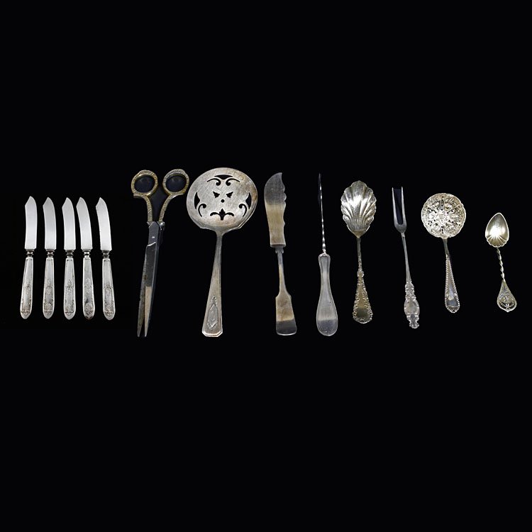 Assorted Silverplate Items: Est. $20 - 30 Assorted Silverplate Items. Sugar sifter, tomato server, knives, Scissors, etc.