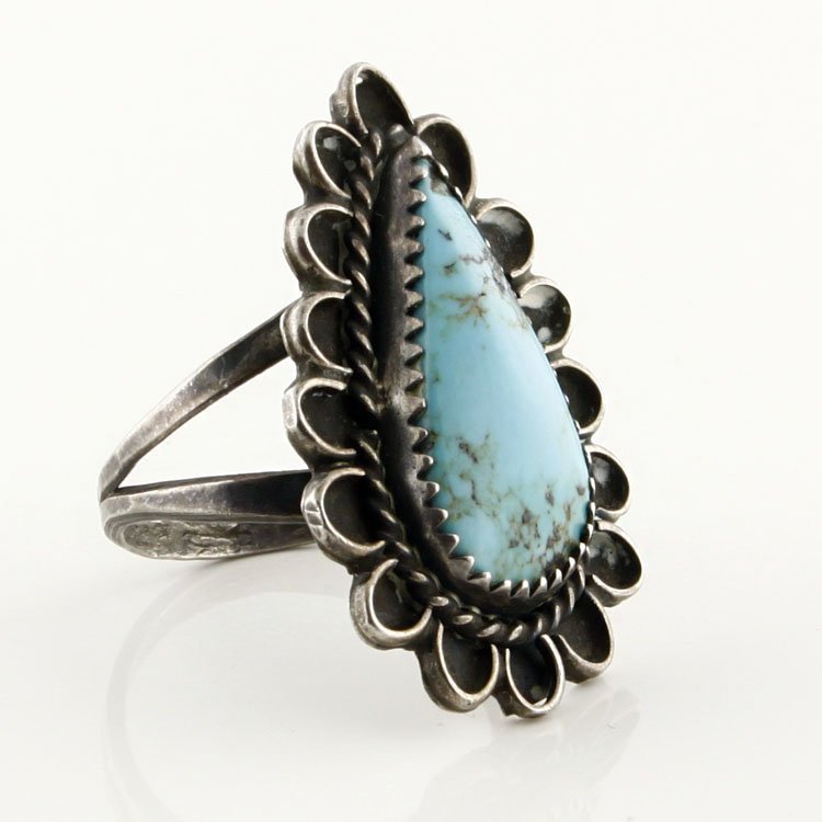 Native American Style Turquoise & Sterling Ring: Est. $50 - 100 Native American Style Turquoise & Sterling Ring. 5.3 gr tw. Sterling with Turquoiose center. Signe by artist "E.M.".