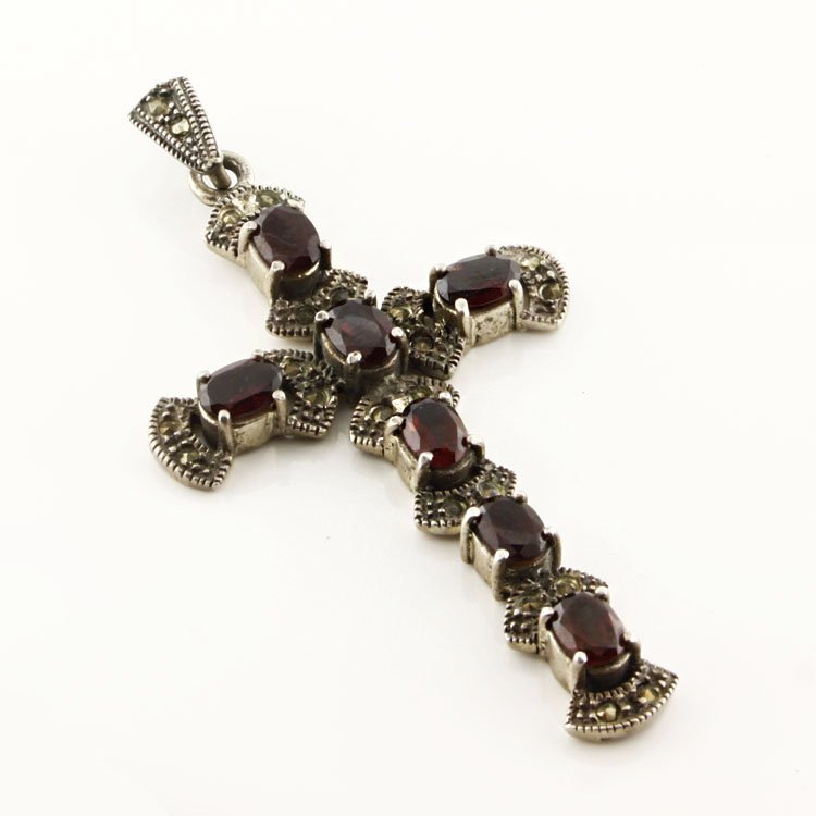 Sterling Gemstone Cross Pendant: Est. $50 - 100 Sterling Gemstone Cross Pendant. 14.3 gr tw. Accented with Garnets and Marcasite. 2 3/4 x 1 1/2". Marks: 925.