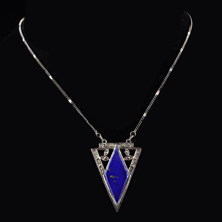 Sterling & Gemstone Necklace: Est. $75 - 125 Sterling & Gemstone Necklace. 10.4 gr tw. Sterling Gemstones: Diamond shaped blue stone with gold flakes. Marcasite accents. Fancy triangle shape measures 1 1/2 x 1". Marks: 925 & G.