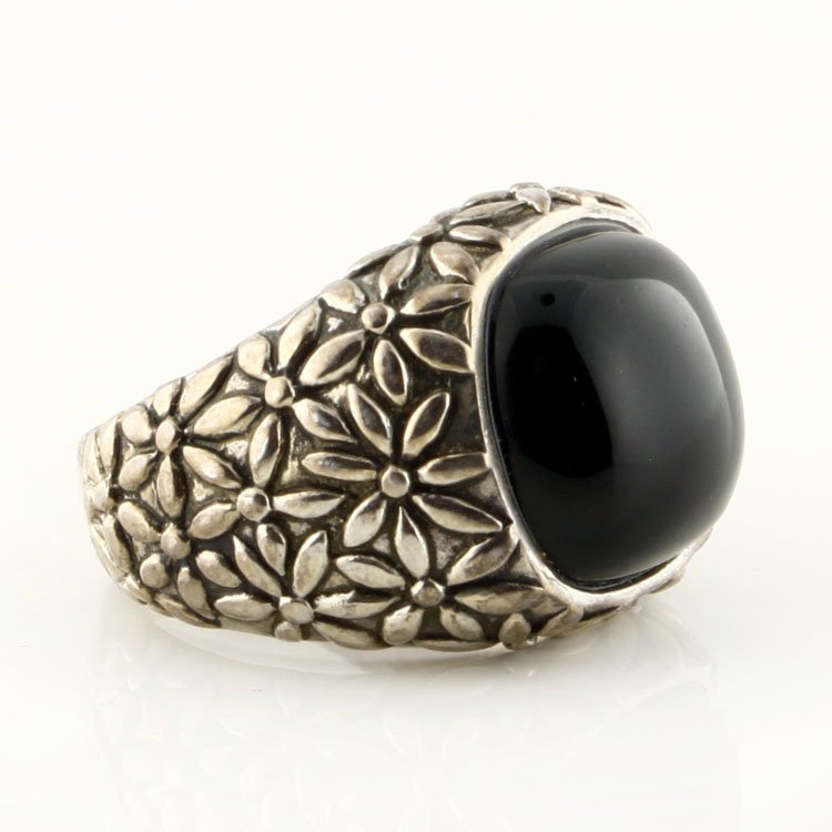 Black Onyx Sterling Ring with Flowers: Est. $60 - 100 Black Onyx Sterling Ring with Flowers. 11.7 gr tw. Sterling. Gemstone: Black Onyx Cabachon. Band has flower pattern. 5/8" at widest point. Marks: 925, Thailand & ATR.