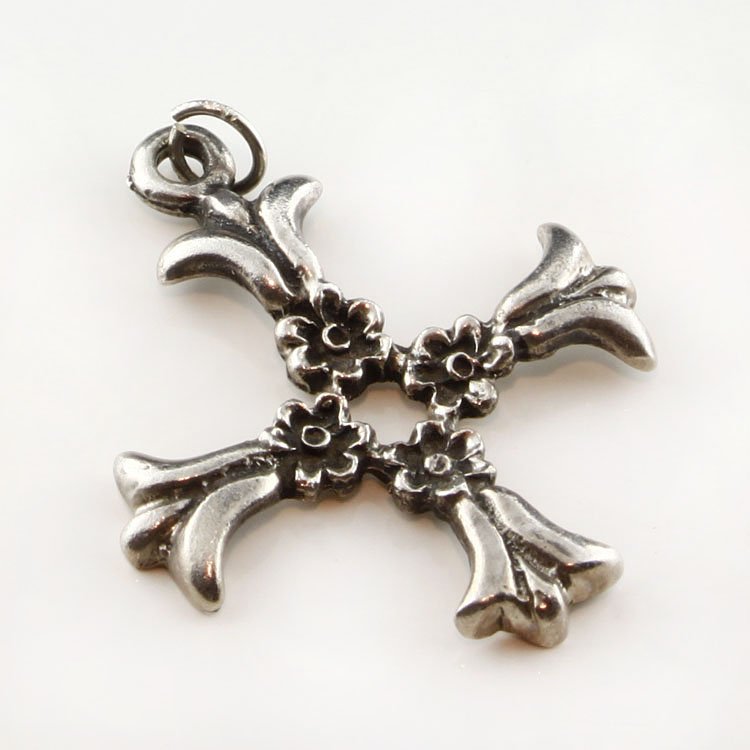Sterling Floral Cross Pendant: Est. $30 - 75 Sterling Floral Cross Pendant. 6.7 gr. Sterling. Cross made with floral elements. 1 1/2 x 1 1/4". Marks: 925.