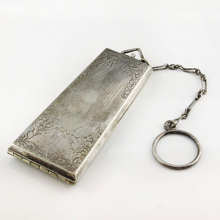 Vintage Silve Coin Compact with Chain: Est. $75 - 125 Vintage Silve Coin Compact with Chain. Nickel silver coin compact with mirror and chain. 3 x 1 1/2" at widest point. Marks: Nickel Silver.
