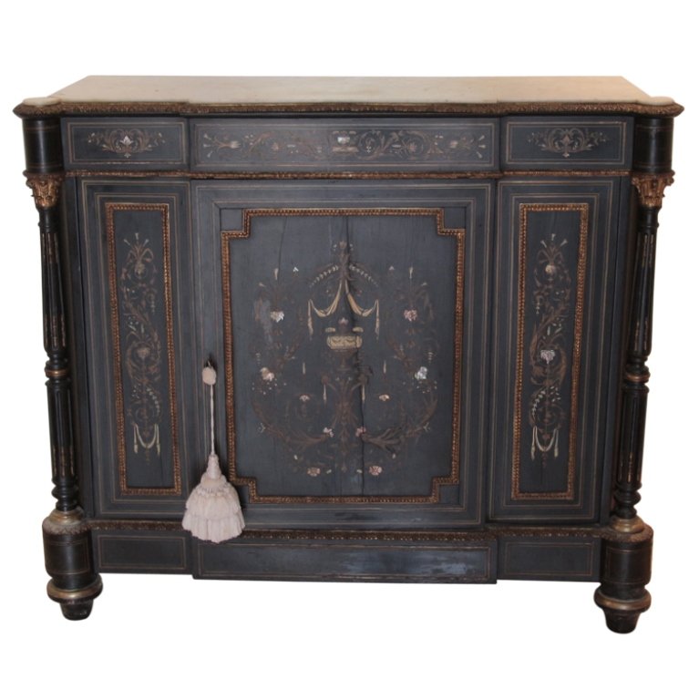 French Side Cabinet: Est. $750 - 1000 French Side Cabinet. Napoleon III style. 1865-1875. Inlay with mother of pearl, bone, brass. Gilt molding, marble top, ebonized wood, some loss to brass inlay. Crack in marble top. 44