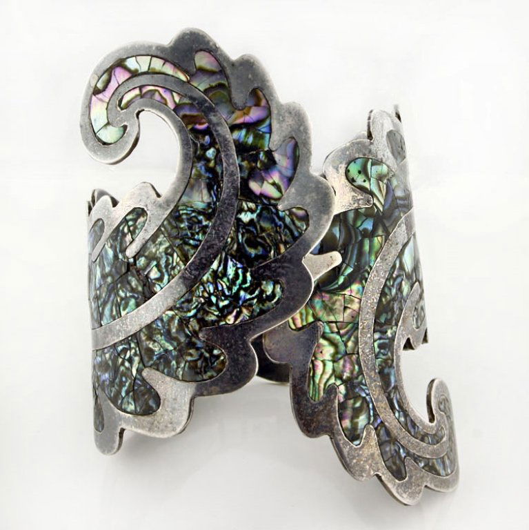 Vtg. Hecho En Mexico Sterling Abalone Bracelet: Est. $200 - 400 Vtg. Hecho En Mexico Sterling Abalone Bracelet. 63.3 gr tw. Sterling hinged bangle bracelet. Figural design with inlaid Abalone. 2 3/4" at widest point. Marks: Hecho En Mexico, 925, ad