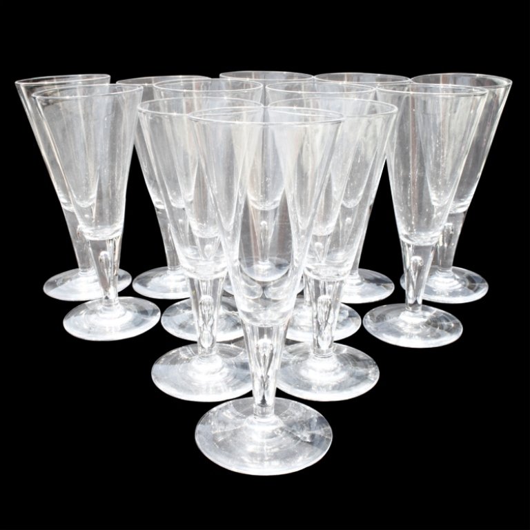 12 Steuben Teardrop Wine Goblets: Est. $2000 - 3000 12 Steuben Teardrop Wine Goblets. 12 marked Steuben Teardrop Wine Goblets. Each glass is approx. 8 1/2" tall. Two glasses are chipped on the base. Third Party Shipping