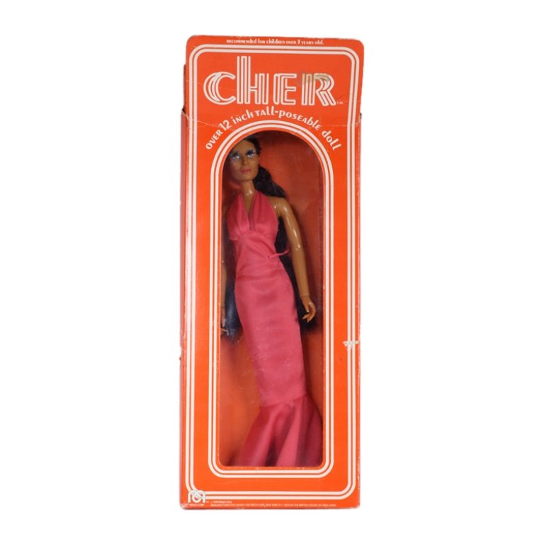Vintage Cher Doll by Mego Corp.: Est. $20 - 50 Vintage Cher Doll by Mego Corp.. TM 1976 Mego Corp. Cher doll in original box (opened) and has been removed from box. Box is worn and torn. Cher doll has both shoes, good condition other