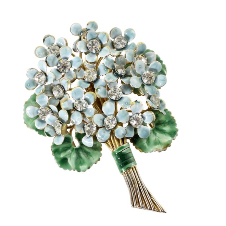 Vintage Sandor Flower Bouquet Brooch: Est. $ 50 - 75 Vintage Sandor Flower Bouquet Brooch. Blue enamel flower with green accents. Gold tone body, rhinestone accents. 2.75 x 2". Marked Sandor.