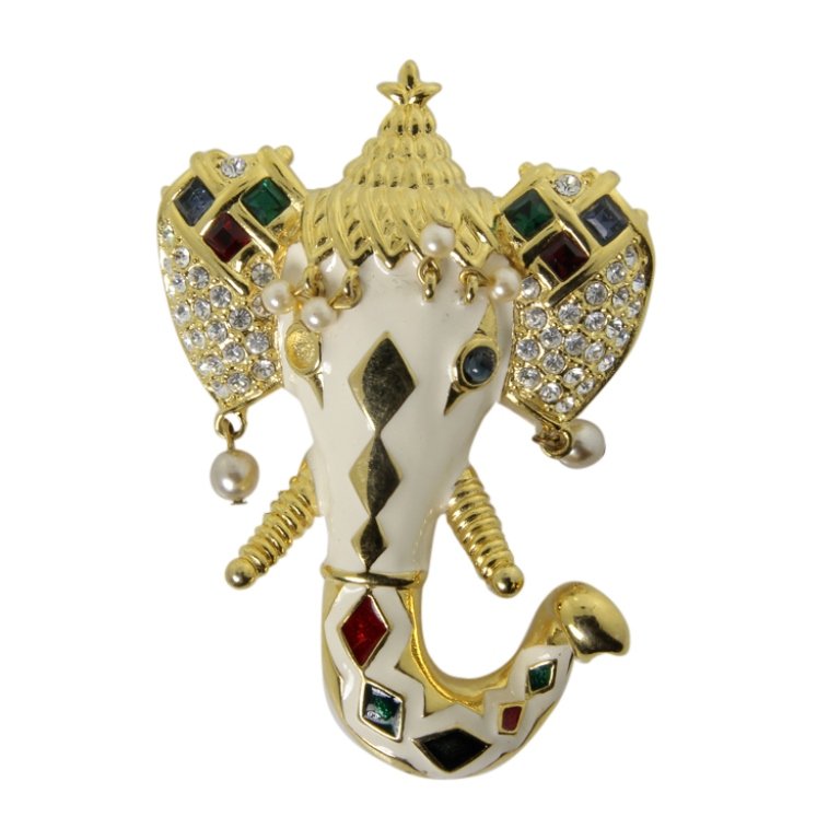 Kenneth J. Lane Elephant Head Brooch: Est. $ 50 - 100 Kenneth J. Lane Elephant Head Brooch. Gold tone brooch in stylized elephant theme. Rhinestones and faux pearls. Missing rhinestone eye. Marked KJL. 3.25 x 2.25 inches.