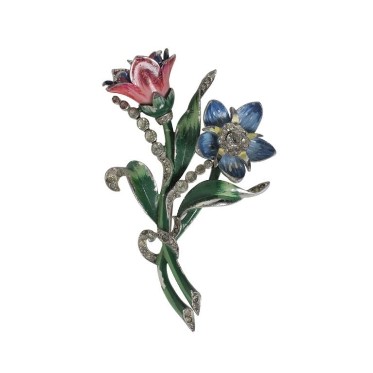 Mazer? Floral Brooch: Est. $ 50 - 100 Mazer? Floral Brooch. Vintage enamel painted and rhinestone floral brooch. Blue flower has play to it. Some loss to enamel. Marked Mazer? 3 x 1.75 inches.