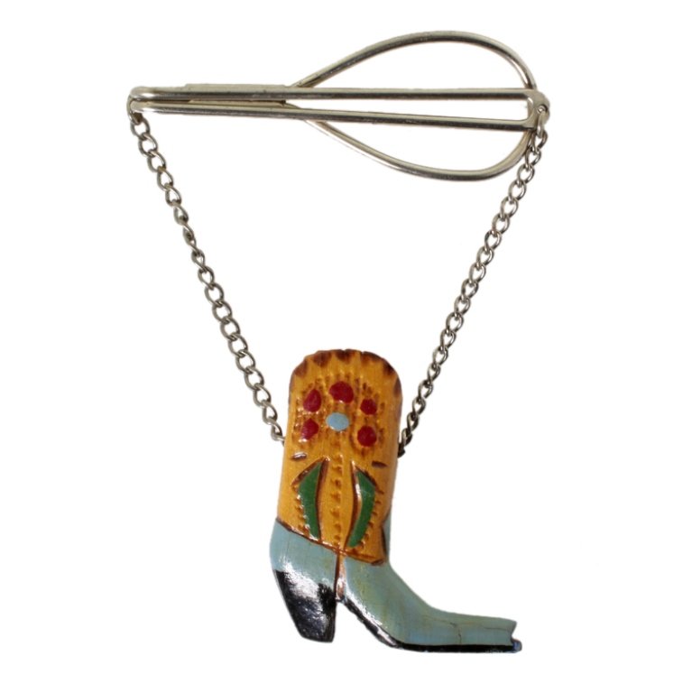 Vintage Wooden Cowboy Boot Tie Clasp: Est. $ 15 - 30 Vintage Wooden Cowboy Boot Tie Clasp. Silver tone clasp with wooden cowboy boot. Length from top of tie clasp to bottom of boot is 3 inches.