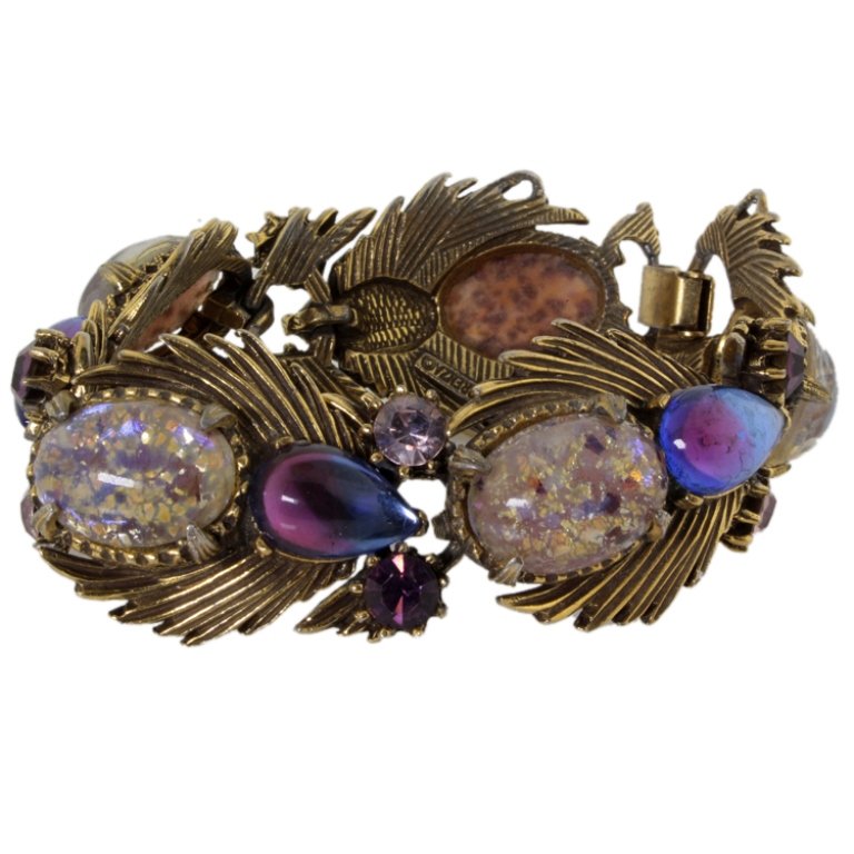 Florenza Foiled Cabochon vintage Bracelet: Est. $ 40 - 75 Florenza Foiled Cabochon vintage Bracelet. Vintage bracelet with foiled cabochons, bi-color pear-shaped cabochons, and purple rhinestones in antiqued gold-tone metal. Marked Florenza. M