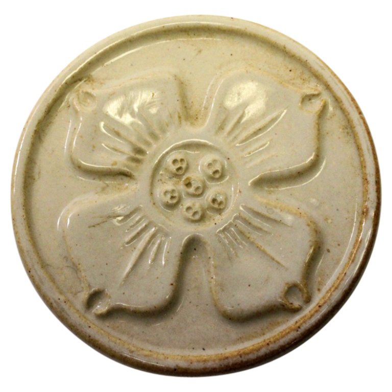 Douglas Ferguson Tile Trivet: Est. $ 25 - 50 Douglas Ferguson Tile Trivet. Round glazed tile trivet in floral theme. Stamped with Douglas Ferfuson mark on reverse. 3.75 inches diameter.