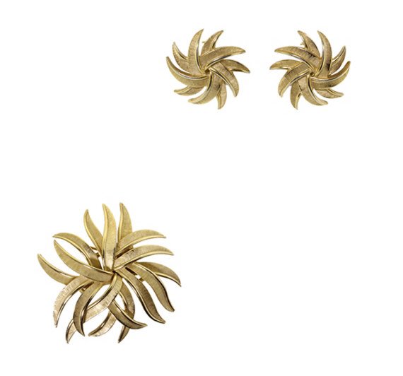 Trifari Brooch and Earring Set: Est. $ 15 - 30 Trifari Brooch and Earring Set. Brooch measures 2.25 inches across. Clip on earrings measure 1 inch. Signed Trifari.