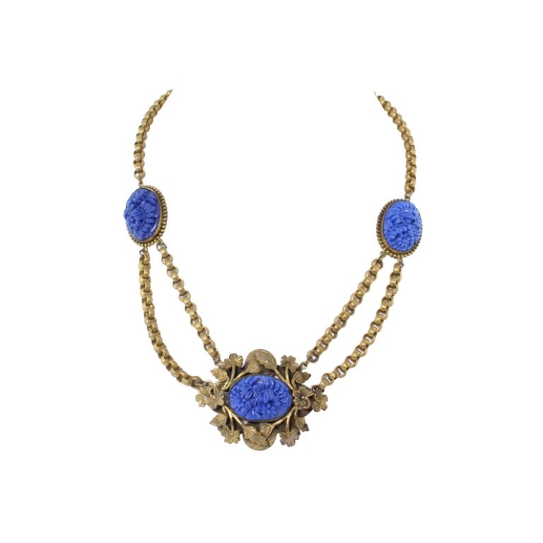 Vintage Floral Necklace: Est. $ 100 - 200 Vintage Floral Necklace. Antiqued gold floral necklace. Molded blue floral center . Chain extension has been added. 18.5 inches long.