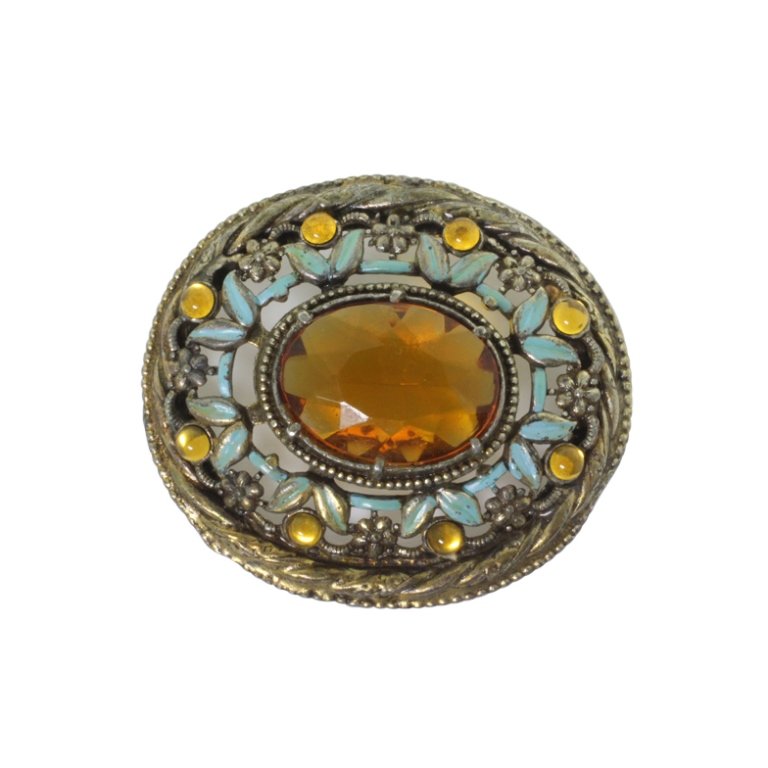 Vintage Pendant: Est. $ 25 - 50 Vintage Pendant. Antiqued tone pendant with oval faceted center and painted enamel accents. Signs of missing brooch pin assembly. 2.75 inches wide.