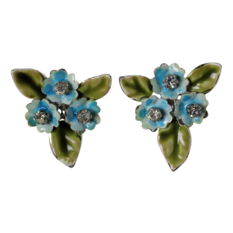 Vintage Coro Floral Earrings: Est. $ 50 - 100 Vintage Coro Floral Earrings. Silver tone clip on earrings in a floral theme with rhinestones and painted enamel accents. Marked Coro. 1.25 inch diameter.