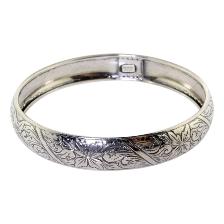 Beau Sterling Bangle: Est. $ 20 - 30 Beau Sterling Bangle. Weighs 15.2 grams. Measures 2.75 inches across. Marked BEAU, Sterling.