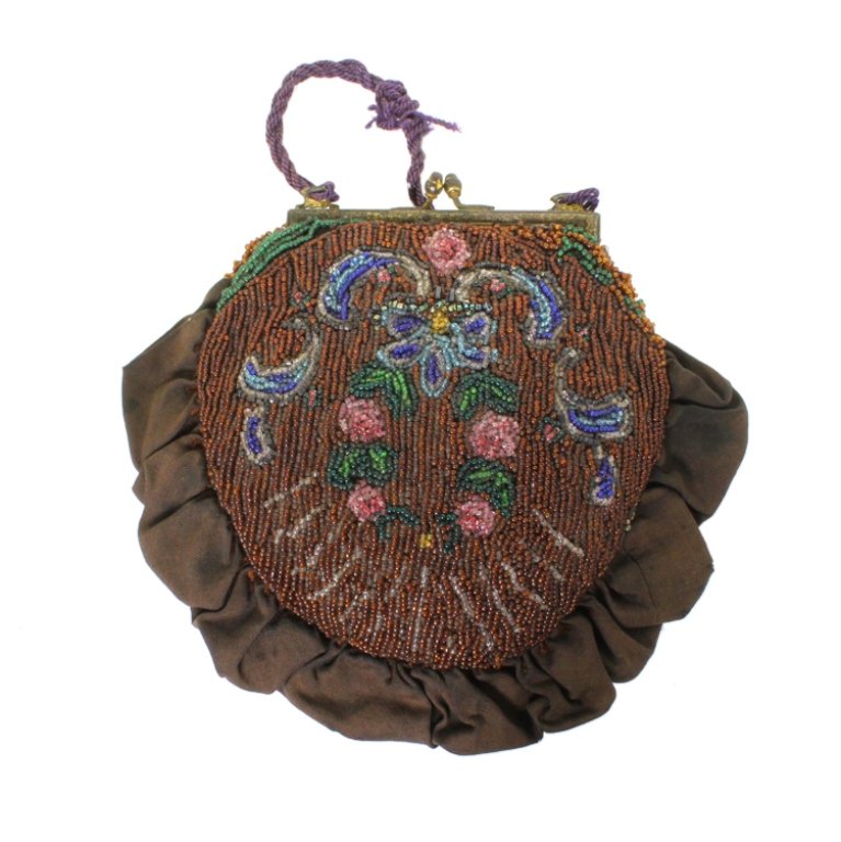 Vintage Beaded Purse: Est. $ 50 - 75 Vintage Beaded Purse. Unmarked beaded purse. Purse is 7 inches long. Corded strap is 7.5 inches total. Minor loss to beads, separation of fabric to metal frame on one side.