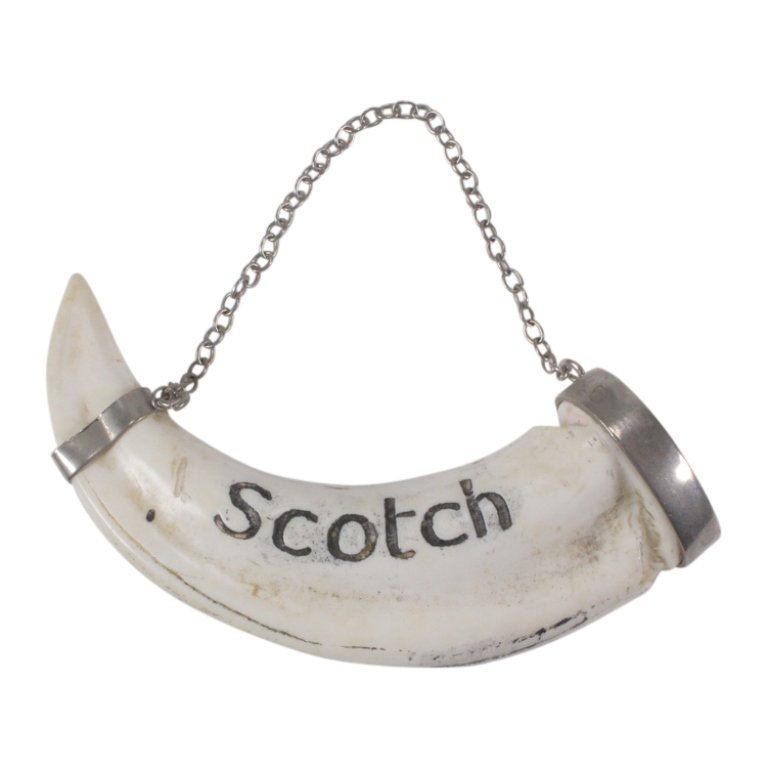 Boar Tusk Scotch Decanter Label: Est. $ 50 - 100 Boar Tusk Scotch Decanter Label. Measures 3.25 inches long. Marked Scotch.