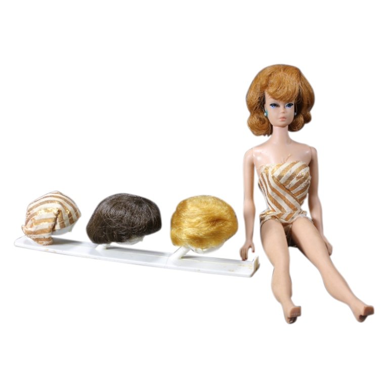 1960s Fashion Queen Barbie with 3 Wigs and Stand: Est. $ 50 - 100 1960s Fashion Queen Barbie with 3 Wigs and Stand. Wig stand included with 3 wigs and turban. Some wear to Barbie and outfit due to age. Blue earrings have bled color into Barbie skin a