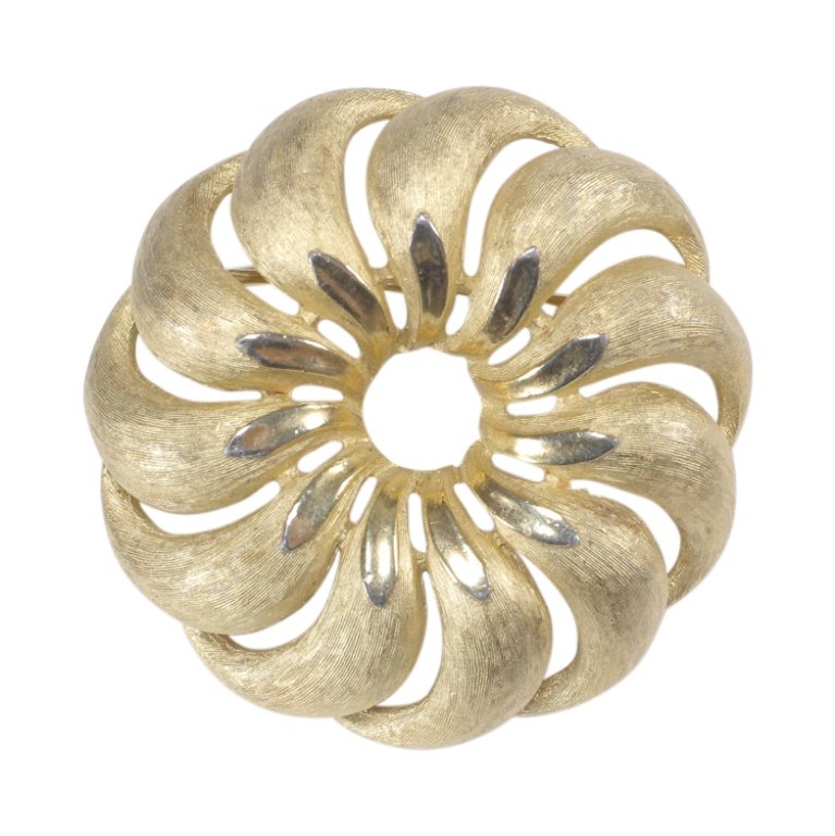 Trifari Goldtone Brooch: Est. $ 20 - 40 Trifari Goldtone Brooch . Measures 1.5 inches in diameter. Marked Trifari.