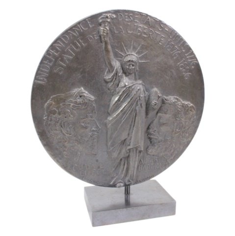 Eiffel Bertholdi Bronze Medallion: Est. $ 100 - 300 Eiffel Bertholdi Bronze Medallion. A 25cm bronze disk commemorating the efforts of Eiffel and Bertholdi. Edge marked Bronze, 1986, No. 8/20