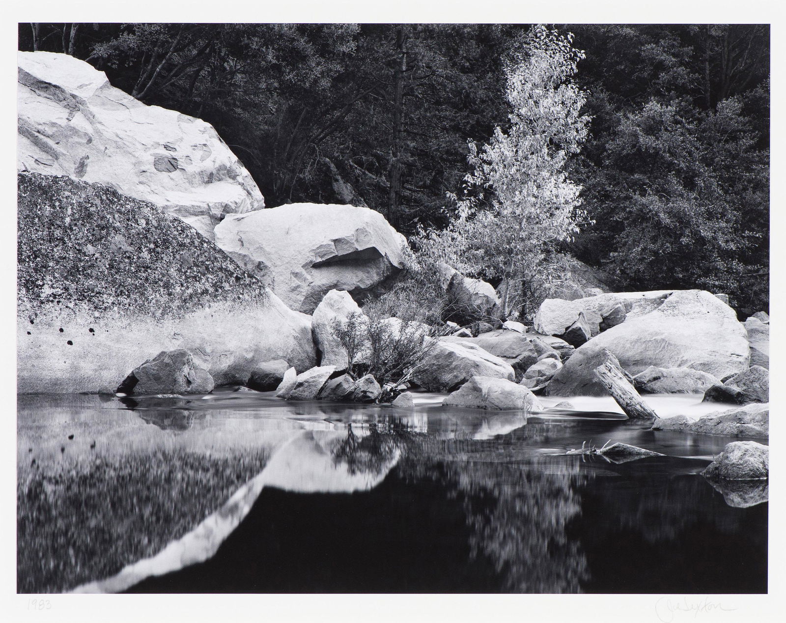 John Sexton Boulders and Tree, Merced River, 1983, printed 2001: John Sexton (American, b. 1953) Boulders and Tree, Merced River, 1983, printed 2001 Gelatin silver print mounted on archival board 9.875 x 13 (in) 16 x 20 (in) mount size Signed in pencil John Sexton,