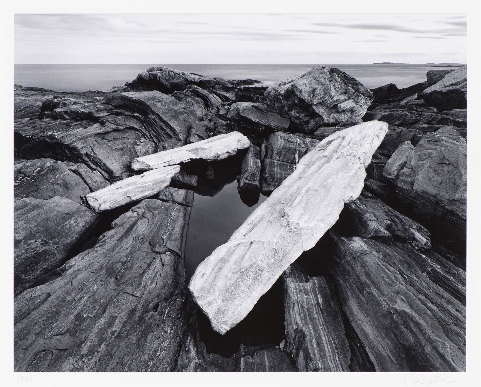 John Sexton Rock Shoreline, Dusk, 1987, printed 2001: John Sexton (American, b. 1953) Rock Shoreline, Dusk, 1987, printed 2001 Gelatin silver print mounted on archival board 10.1875 x 12.875 (in) 16 x 20 (in) mount size Signed in pencil John Sexton, lowe