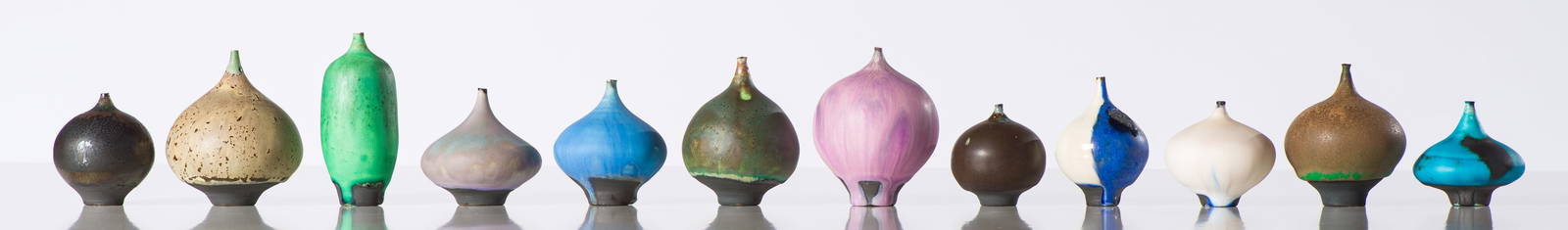 Rose Cabat (12) Feelie Vases: Rose Cabat (American, 1914-2015) (12) Feelie Vases Glazed stoneware 3.75 x 3 x 3 (in) Incised CABAT, bottom of each work Dimensions reflect the largest work, Large Tan Speckled Teardrop Feelie. Smalle