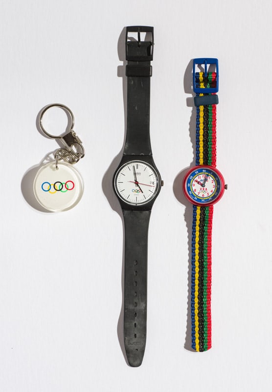 (1) Key Chain 1996 Olympics & (1) Men's Olympic Watch, (1) Swatch Flik Flak USA Olympics: Key Chain 1996 Olymics. 1996. Men's Olympic Watch (GZ400). Quartz. Plastic Case Material. Plastic Strap. Pin Buckle. Swatch Flik Flak USA Olympics watch (FFU100). 1996. Ed. 7331. Quartz. Plastic Case