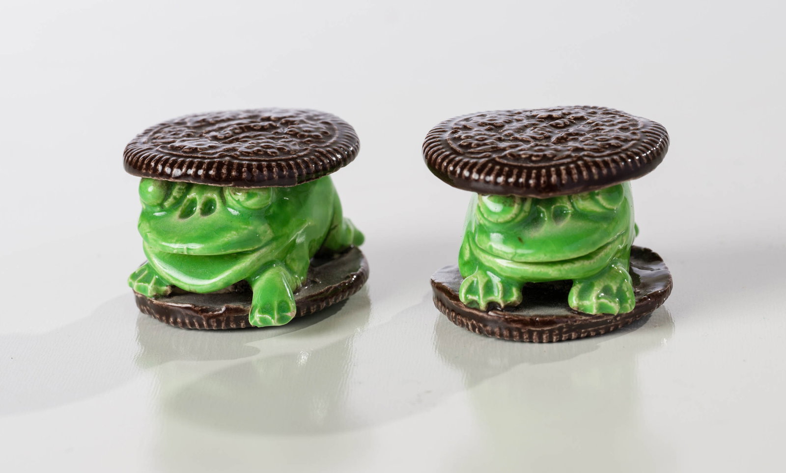 David Gilhooly (2) Hydrox Cookie Frogs: David Gilhooly (American, 1943-2013) (2) Hydrox Cookie Frogs Ceramic with glaze 1.25 x 1.75 x 2 (in) Incised Gilhooly, underside of cookie on each work Dimensions reflect each work. Provenance: Privat